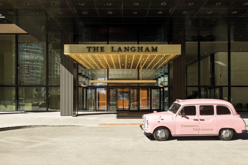 Front entrance of The Langham with old pink cab out front.